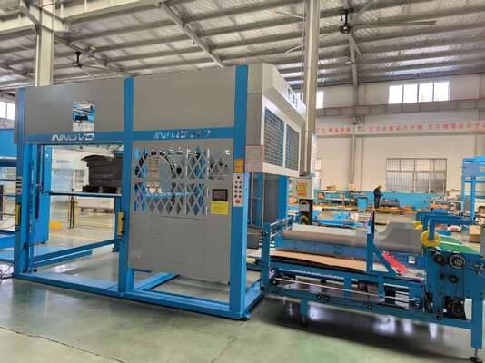 Macchina impilatrice automatica a ribaltamento che integra tavolo carta lento e componenti di sistema per la svolgitura e l'impilamento di flauto in produzione di imballaggi